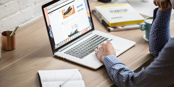 Person working on a laptop at a desk