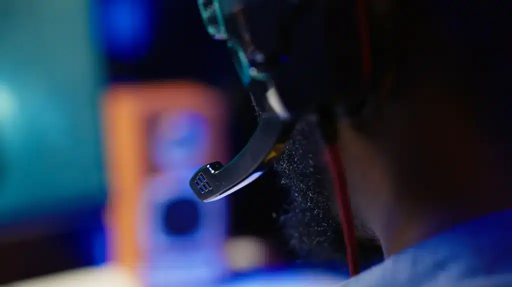 Person using headset with microphone, blurred background.